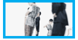 Blurry, low-resolution image of several people in dark coats walking, with a child in patterned clothing at center.