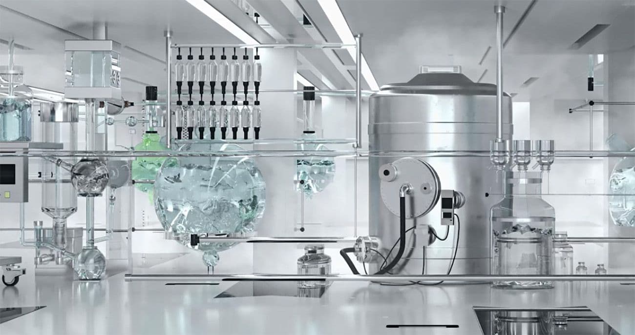 Glass-walled lab installation with chemical processing equipment, bottles, and tubing on a white countertop.