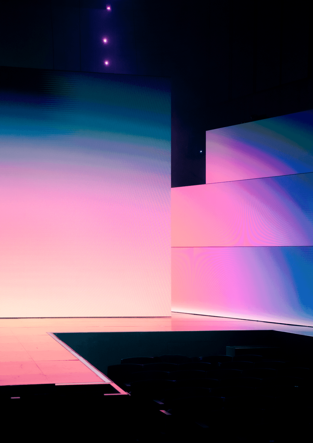 Empty stage with pastel pink-to-blue gradient staggered panels.
